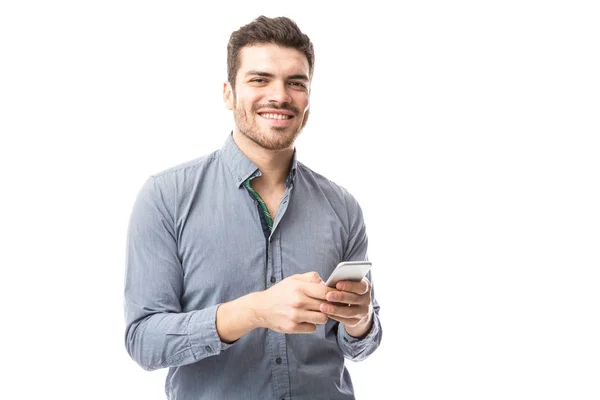 Handsome young man checking smartphone — Stock Photo, Image