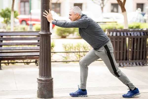 Full Length Hispanic Mature Man His 50S Doing Stretching Exercises — Stock Photo, Image