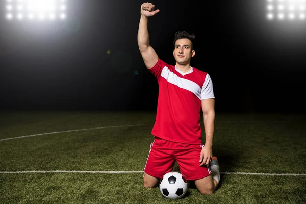 Football Player Knees Raising His Arm Scoring Goal Winning Competition — Stock Photo, Image