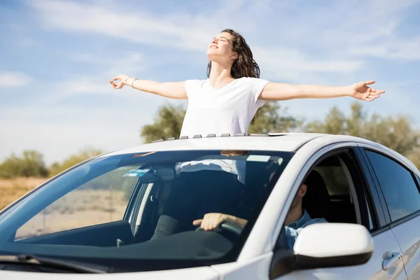 Woman Standing Out Sunroof Arms Outstretched — Stock Photo, Image