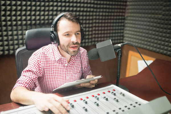 young man with beard hosting show live on radio station