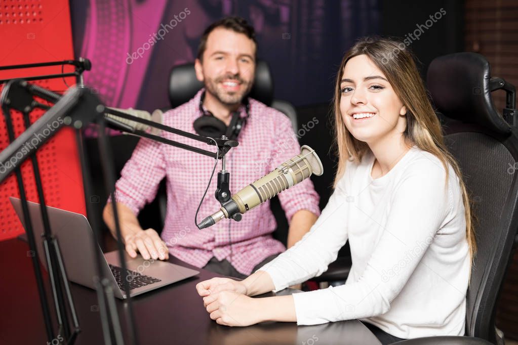 Male radio presenter hosting an interview with famous woman at radio station