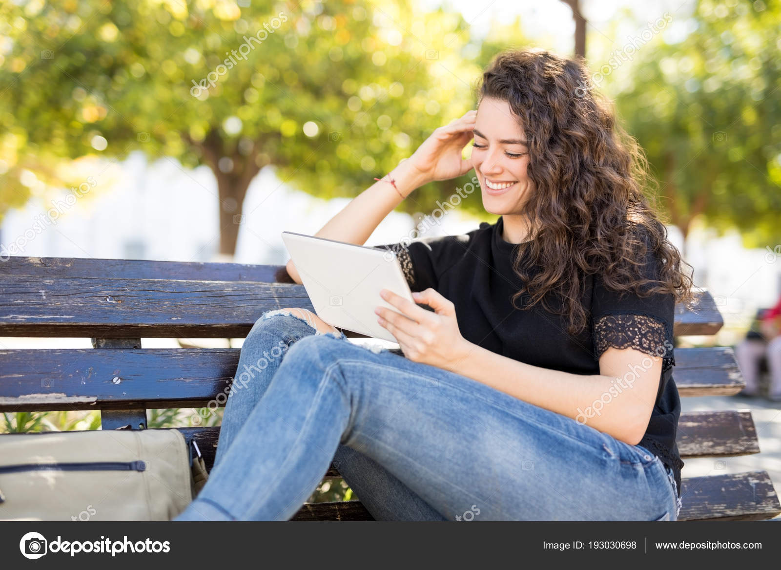 Relaxed Young Woman Sitting Park Bench Using Digital Tablet