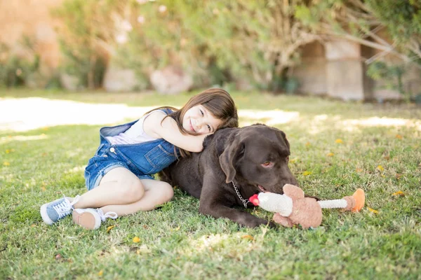 Menina Sorridente Abraçando Com Cão Enquanto Descansa Costas — Fotografia de Stock