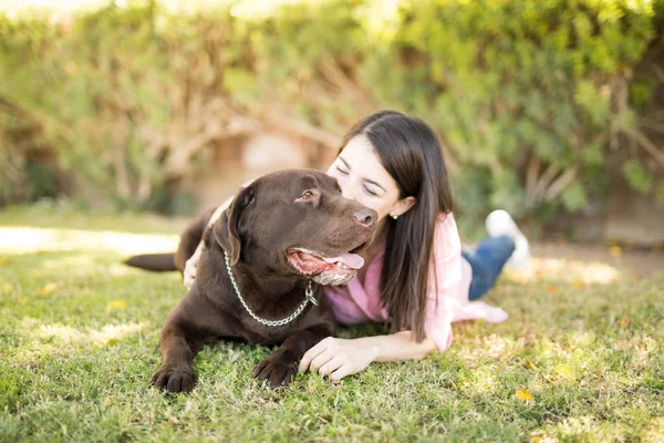 Portrait Tongue Out Pet Dog Being Kissed Woman Owner Park — Stock Photo, Image