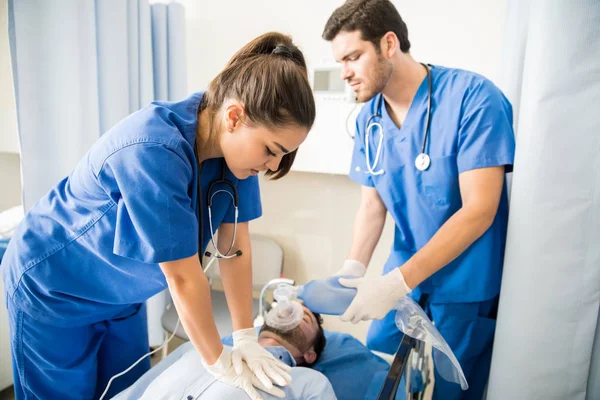 Two Doctors Giving Cpr Unconscious Male Patient Lying Bed Emergency — Stock Photo, Image
