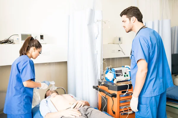 Male Female Doctors Working Unconscious Patient Emergency Room — Stock Photo, Image
