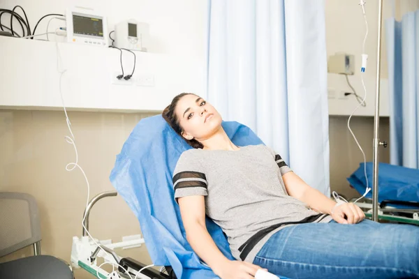 Jovem Mulher Latina Deitada Cama Hospital Com Gotejamento Olhando Preocupado — Fotografia de Stock