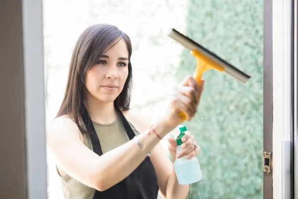 Retrato Joven Mujer Latina Enfocada Limpiando Ventana Cristal Con Spray — Foto de Stock
