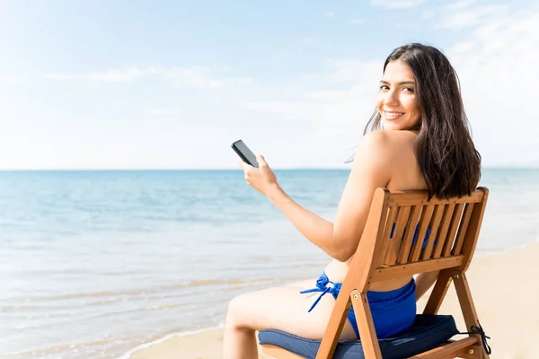 Smiling Woman Using Smartphone While Sitting Chair Shore Beach — Stock Photo, Image