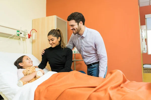 Smiling Parents Looking Daughter Undergoing Treatment Hospital Visit — Stock Photo, Image