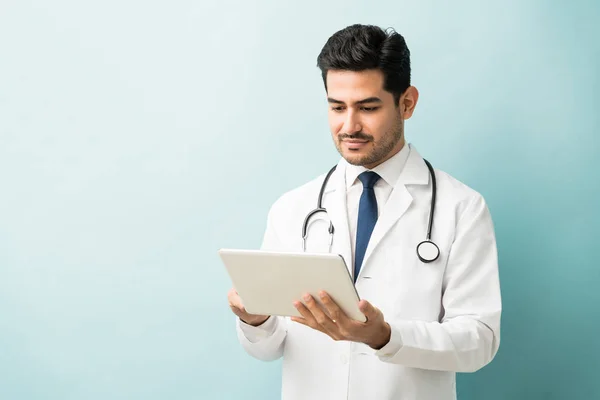 Young Doctor Using Digital Tablet Isolated Blue Background — 图库照片