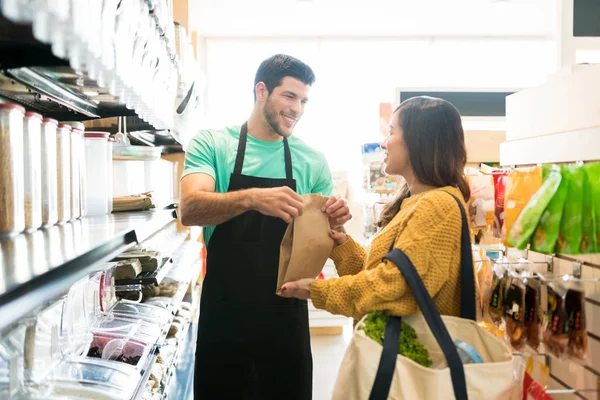 Smiling Male Owner Giving Paper Bag Female Customer Selling Food — Stockfoto
