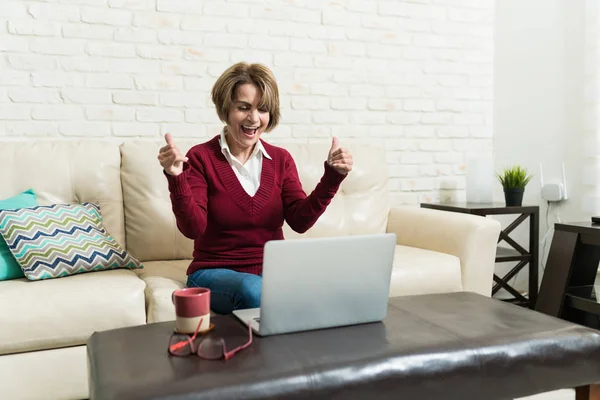 Senior Woman Cheering While Looking Laptop Living Room — Stockfoto