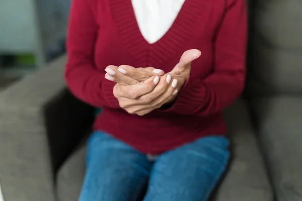 Midsection Senior Woman Massaging Hand While Sitting Sofa — ストック写真