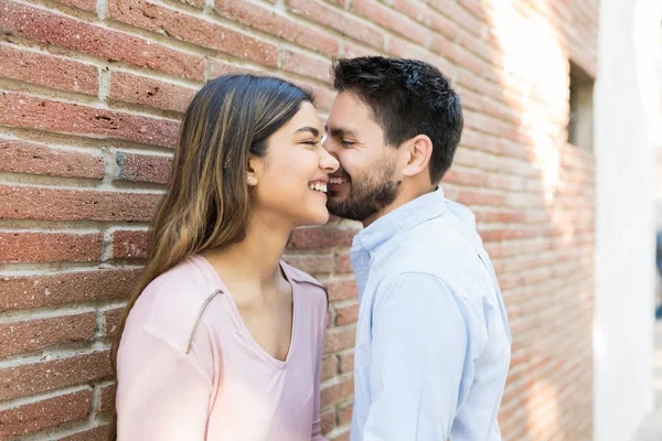 Smiling Hispanic Boyfriend Girlfriend Leaning Brick Wall — Stockfoto