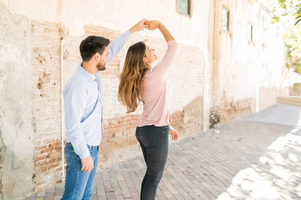 Latin Man Holding Hand Girlfriend Spinning While Dancing Footpath Date — Stock Photo, Image