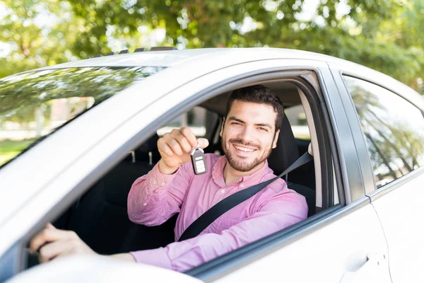 Happy Latin Man Showing Key While Sitting New Car — Stock fotografie