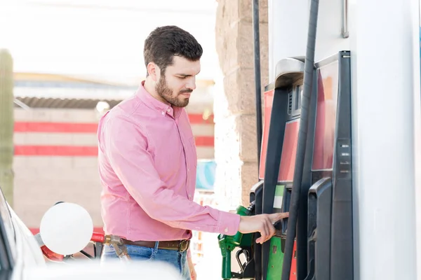 Hispanic Young Adult Man Operating Fuel Pump Machine Self Service — ストック写真