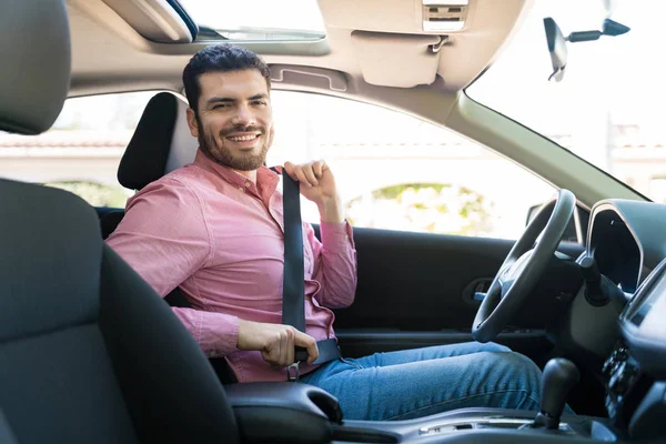 Smiling Hispanic Man Fastening Seatbelt While Sitting New Car — 图库照片