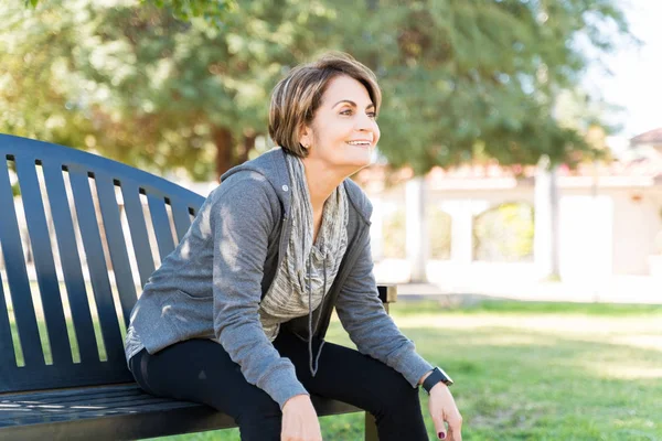 Happy Retired Elderly Woman Looking Away While Sitting Bench Park — Stock Photo, Image