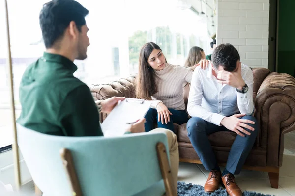 Wife Trying Comfort Depressed Husband While Sharing Problems Male Therapist — Stock Photo, Image