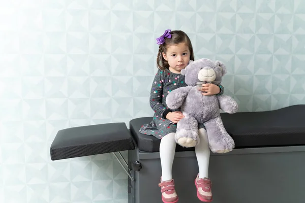 Schattig Klein Meisje Met Teddybeer Zittend Tafel Het Ziekenhuis — Stockfoto