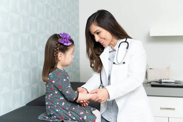 Pewna Siebie Uśmiechnięta Lekarka Nakładająca Bandaż Przylepny Dłoń Małej Dziewczynki — Zdjęcie stockowe