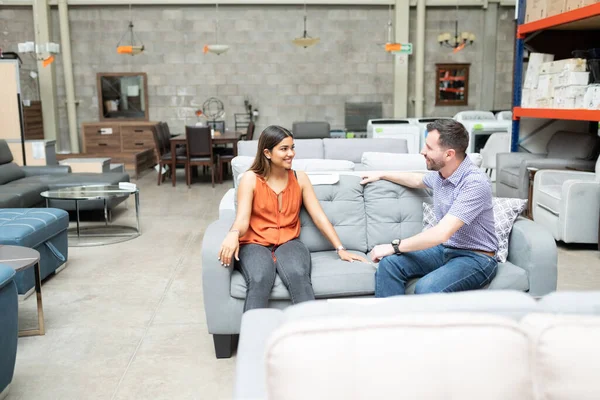 Smiling Latin Couple Talking While Looking Each Other Sitting Sofa — Stock Photo, Image