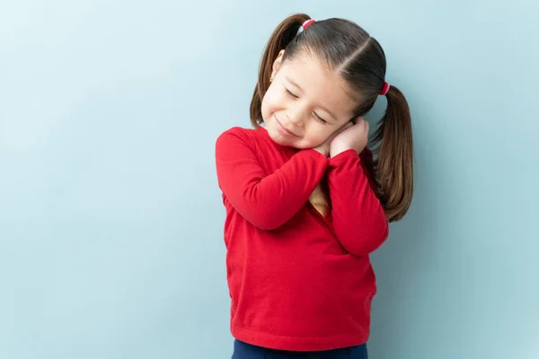 Mooi Klein Meisje Sluiten Haar Ogen Dagdromen Een Blauwe Achtergrond — Stockfoto