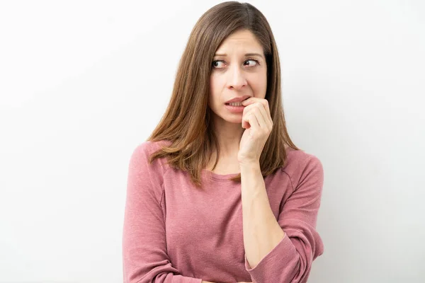 Attractive Woman Her 40S Looking Nervous Biting Her Nails Studio — Stock Photo, Image