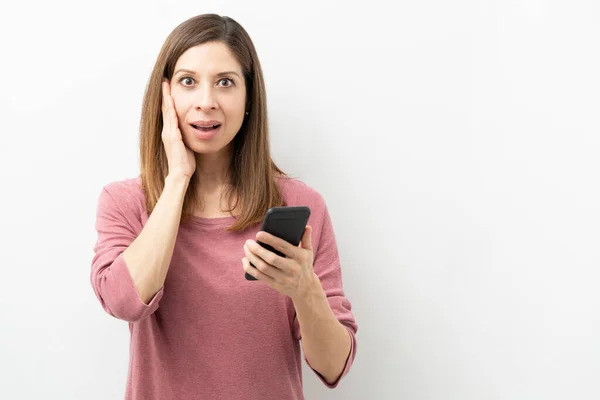 Portrait Brunette Woman Holding Smartphone Looking Shocked Suprised Studio — Stock Photo, Image