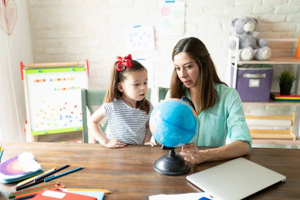 Mãe Pequena Menina Aprendendo Alguma Geografia Usando Globo Enquanto Fazendo — Fotografia de Stock