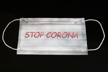 Solunum hastalığının siyah arka planında tıbbi maske. Hastalığa çare. Coronavirus. Tüm dünyada salgın var.