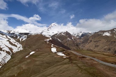 Kazbek dağının zirvesi bulutlarda. Kazbek Dağı 'nın zirvesi. Karla kaplı Kazbek dağı zirvesi..
