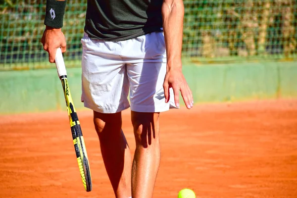 Close up photo of professional tennis player with a racket and a tennis ball. — Stock Photo, Image