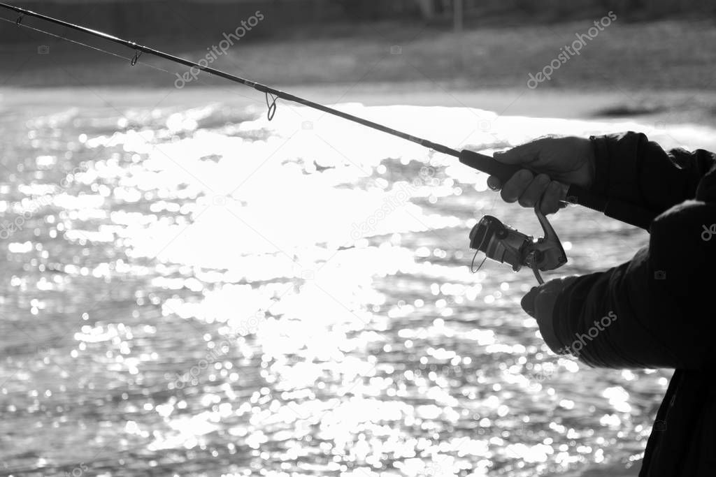 Fishing rod. Spinning reel black and white image with copy space.