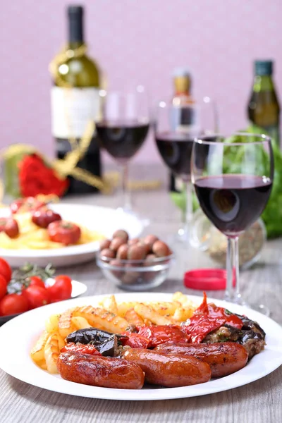 French fries and sausage on the dish Stock Image