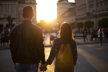 Silhouettes of a loving couple holding hands