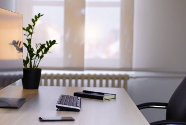Nice and neat office work place by the window 