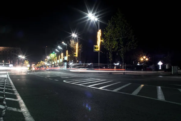 Junction square. Cars passing. Some pedestrians. Christmas/New Year decorations. Modern lighting. 282