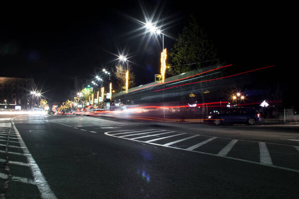 Junction square. Cars passing. Some pedestrians. Christmas/New Year decorations. Modern lighting. 343