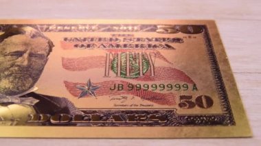 Golden 50 fifty dollar bill Very close up Camera travels over it. Macro shot. $