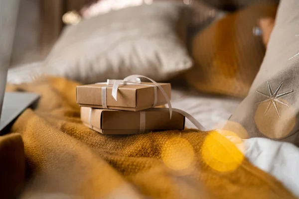 wrapped Christmas gifts on a bed