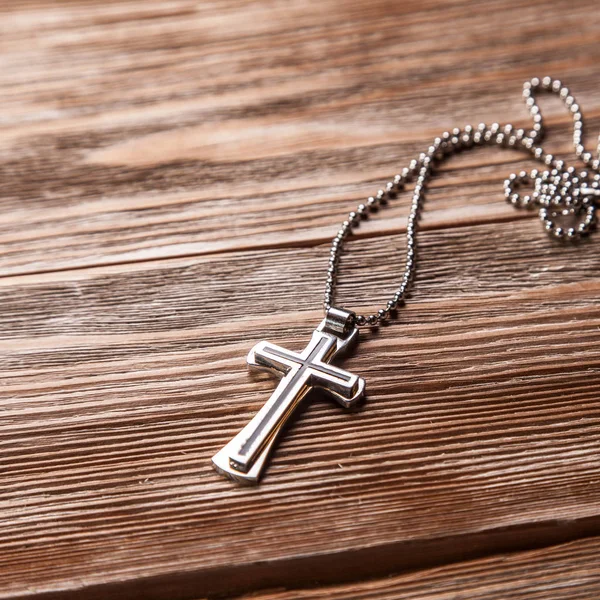 Old cross on a brown wood — Stock Photo, Image