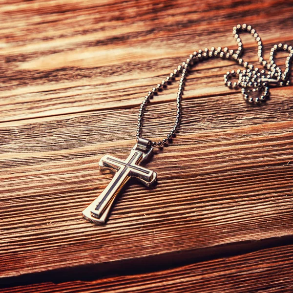 Old cross on a brown wood — Stock Photo, Image