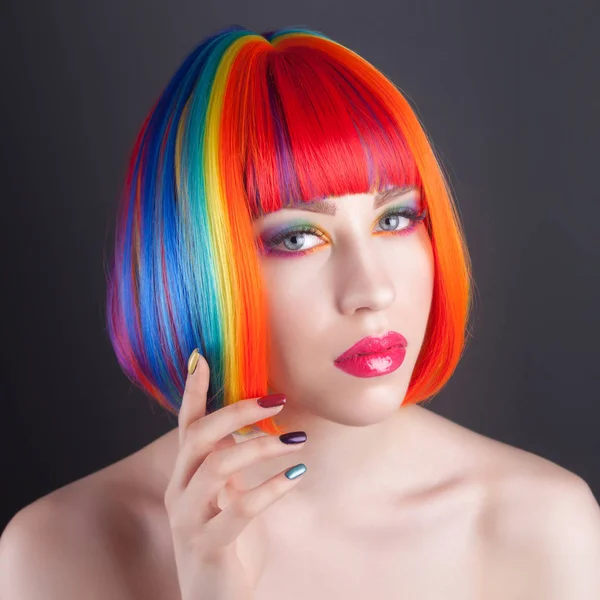 Beautiful woman wearing colorful wig and showing colorful nails — Stock Photo, Image