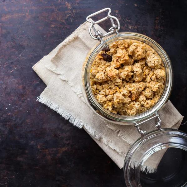 Homemade muesli granola in a jar on rusty black table — Stock Photo, Image