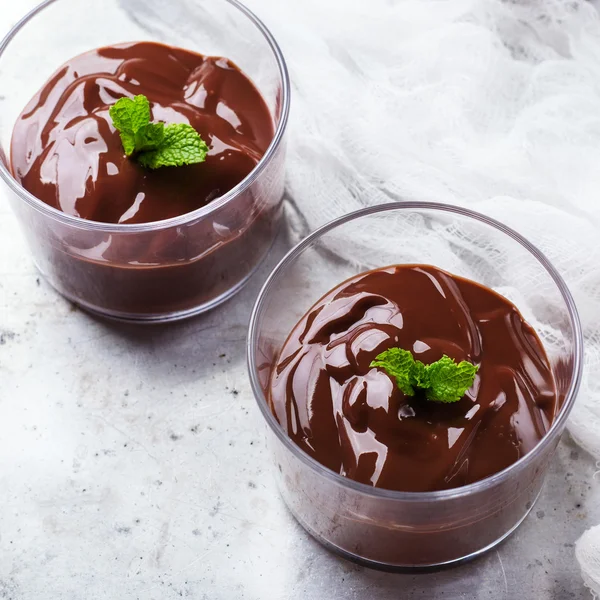 Chocolate mousse with mint in glass on rustic table — Stock Photo, Image