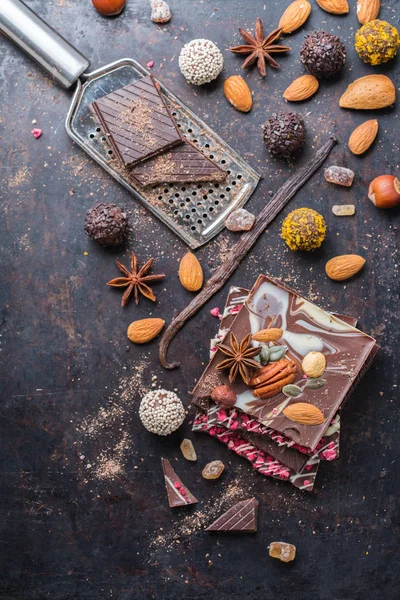 Stack of chocolate bars and praline truffle with spices — Stock Photo, Image